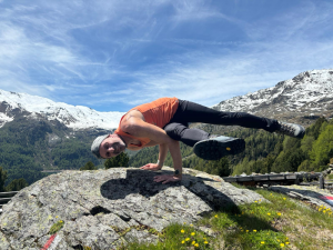 Daniel Kuom Outdoor macht Yoga Pose auf einem Felsen